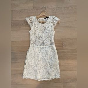 White lace open back mini dress in size M